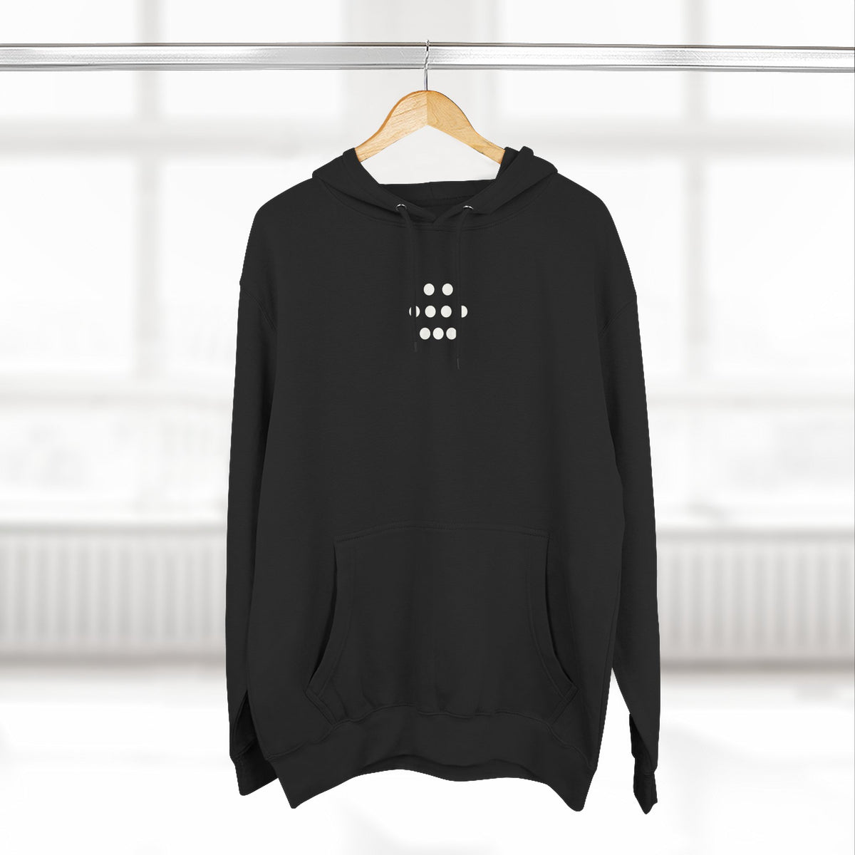 Black nine-dot hoodie on a hanger